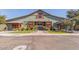 Charming clubhouse with barn-style architecture and lush landscaping creates a welcoming community space at 14571 W Wethersfield Rd, Surprise, AZ 85379