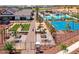 An aerial view of community amenities showcasing a pool, sport court, gardens, and walking paths at 14571 W Wethersfield Rd, Surprise, AZ 85379