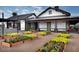 The community features an outdoor space with garden beds in front of a modern clubhouse at 14571 W Wethersfield Rd, Surprise, AZ 85379