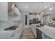 Well-equipped kitchen boasts stainless steel appliances, a center island with sink, and modern finishes at 14571 W Wethersfield Rd, Surprise, AZ 85379