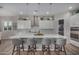 Stylish kitchen island featuring pendant lighting, seating, and modern appliances, creating a perfect gathering spot at 14571 W Wethersfield Rd, Surprise, AZ 85379
