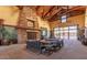 Elegant lounge area with a stone fireplace and comfortable seating creates a warm and inviting atmosphere at 14571 W Wethersfield Rd, Surprise, AZ 85379