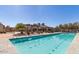 Inviting pool featuring sundeck areas and comfortable seating, perfect for outdoor relaxation and entertainment at 14571 W Wethersfield Rd, Surprise, AZ 85379