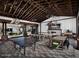 A recreation room with exposed timber ceiling beams featuring a ping pong table, seating and a fireplace at 14571 W Wethersfield Rd, Surprise, AZ 85379