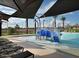 A community zero entry pool with a playful water feature for children and lounge chairs at 14571 W Wethersfield Rd, Surprise, AZ 85379