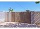 Secured backyard featuring wooden gate and block wall for privacy, leading to concrete slab at 1532 W 6Th St, Tempe, AZ 85281