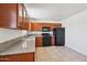 Spacious kitchen equipped with wood cabinets, sleek black appliances, and plenty of counter space for food preparation at 1532 W 6Th St, Tempe, AZ 85281