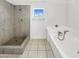 Bright bathroom featuring a large soaking tub and walk-in shower at 15650 N 19Th Ave # 1206, Phoenix, AZ 85023