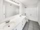 Bright bathroom features double sinks, a white vanity and tile flooring at 15650 N 19Th Ave # 1206, Phoenix, AZ 85023