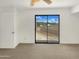Bright bedroom featuring sliding glass doors leading to a balcony with neighborhood views at 15650 N 19Th Ave # 1206, Phoenix, AZ 85023
