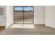 Bright bedroom with carpeted floors, white walls, and a sliding glass door to the patio at 15650 N 19Th Ave # 1206, Phoenix, AZ 85023