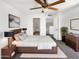 Cozy bedroom featuring a ceiling fan, and an ensuite bathroom and walk in closet at 15650 N 19Th Ave # 1206, Phoenix, AZ 85023