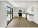 Contemporary kitchen features sleek white cabinets, stainless steel appliances, and outdoor access at 15650 N 19Th Ave # 1206, Phoenix, AZ 85023