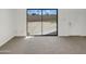 Spacious room features neutral carpet and sliding glass doors leading to the backyard at 15650 N 19Th Ave # 1206, Phoenix, AZ 85023