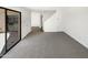 Open-concept living room featuring neutral walls and carpet flooring and sliding door access at 15650 N 19Th Ave # 1206, Phoenix, AZ 85023
