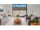 Living room boasts contemporary furniture, a plush rug and sliding glass doors to the backyard at 15650 N 19Th Ave # 1206, Phoenix, AZ 85023
