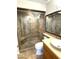 Bathroom featuring a glass-enclosed shower with tiled walls and modern fixtures at 1633 E Lakeside Dr # 154, Gilbert, AZ 85234