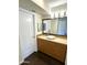 Bathroom featuring a vessel sink, wood cabinets, and neutral countertops at 1633 E Lakeside Dr # 154, Gilbert, AZ 85234