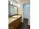 Bathroom with undermount sink, wooden cabinets, and a walk-in closet at 1633 E Lakeside Dr # 154, Gilbert, AZ 85234