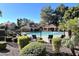 Community pool area features lounge chairs, mature landscaping and covered pavilion at 1633 E Lakeside Dr # 154, Gilbert, AZ 85234
