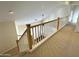 Upstairs hallway with carpet flooring and a light-filled view of the living room at 1633 E Lakeside Dr # 154, Gilbert, AZ 85234
