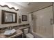 Bathroom with a shower, vanity sink, and decorative mirror at 16461 W Central St, Surprise, AZ 85388