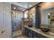 Bathroom featuring decorative tile, a glass-enclosed shower, and modern vessel sinks at 16461 W Central St, Surprise, AZ 85388