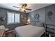 Comfortable bedroom with a ceiling fan, natural light, and stylish decor at 16461 W Central St, Surprise, AZ 85388