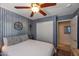 Cozy bedroom featuring a ceiling fan and a decorative accent wall at 16461 W Central St, Surprise, AZ 85388