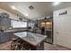 Kitchen with gray cabinetry, granite counters, and a stainless steel refrigerator at 16461 W Central St, Surprise, AZ 85388