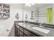 This bathroom features a double sink with granite countertops and a shower at 1649 W Royal Palm Rd, Phoenix, AZ 85021