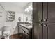 This bathroom features a double sink with granite countertops and dark wood cabinetry at 1649 W Royal Palm Rd, Phoenix, AZ 85021