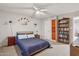 This bedroom features a ceiling fan, a bookshelf and neutral-colored walls at 1649 W Royal Palm Rd, Phoenix, AZ 85021