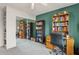 Bedroom features a desk, a bookshelf, and a sliding closet with mirrored doors at 1649 W Royal Palm Rd, Phoenix, AZ 85021