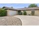 Well-maintained home featuring an attached garage and a spacious driveway with desert landscaping at 1649 W Royal Palm Rd, Phoenix, AZ 85021