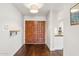 Foyer with beautiful wood floors and a large wooden door leading to other rooms at 1649 W Royal Palm Rd, Phoenix, AZ 85021