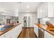 Open kitchen with white cabinets, butcher block countertops, and stainless-steel appliances at 1649 W Royal Palm Rd, Phoenix, AZ 85021