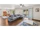 Spacious living room area with hardwood floors, gray sofa, and sliding glass doors to the patio at 1649 W Royal Palm Rd, Phoenix, AZ 85021