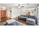 Living room with hardwood floors, a gray sofa, and an open layout leading to the dining area at 1649 W Royal Palm Rd, Phoenix, AZ 85021