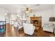 Open concept living area showcases brick fireplace, view to the kitchen, and wood floors at 1649 W Royal Palm Rd, Phoenix, AZ 85021