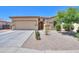 Charming single-story home with a well-manicured lawn, desert landscaping, and a two-car garage at 1761 N Hester Trl, Casa Grande, AZ 85122