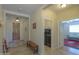 Inviting foyer with tile flooring, a decorative rug, and views into the laundry room and living area at 1761 N Hester Trl, Casa Grande, AZ 85122