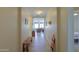 Long hallway featuring tile flooring, neutral walls, and views into the living spaces at 1761 N Hester Trl, Casa Grande, AZ 85122