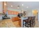 Open kitchen featuring granite counters, stainless appliances, and bar seating at 1761 N Hester Trl, Casa Grande, AZ 85122