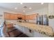 Bright and spacious kitchen featuring a granite breakfast bar and stainless steel appliances at 1761 N Hester Trl, Casa Grande, AZ 85122