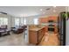 Open concept kitchen with granite countertops, stainless steel appliances, and a breakfast bar at 1761 N Hester Trl, Casa Grande, AZ 85122