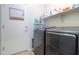 Functional laundry room with a washer, dryer, and shelving for storage at 1761 N Hester Trl, Casa Grande, AZ 85122