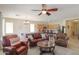 Spacious living room with comfortable seating, ceiling fan, and a view into the kitchen area at 1761 N Hester Trl, Casa Grande, AZ 85122