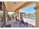 Outdoor patio with a pool, outdoor kitchen, seating area, and lovely landscaping at 1761 N Hester Trl, Casa Grande, AZ 85122