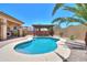 Inviting backyard oasis featuring a sparkling pool, spa, pergola, and lush desert landscaping at 1761 N Hester Trl, Casa Grande, AZ 85122